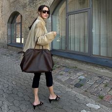 Woman carrying The Row Margaux bag