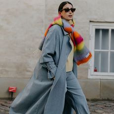 showgoer wearing denim coat and colorful scarf