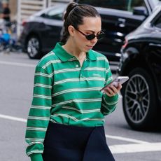 Woman wearing greey rugby shirt and black mini skirt during New York Fashion Week