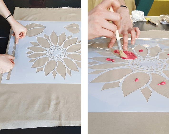 Using stencil to paint holiday design on floor mat fabric