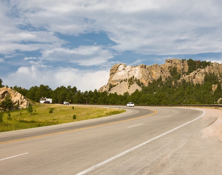 Open highway with cliff in the background