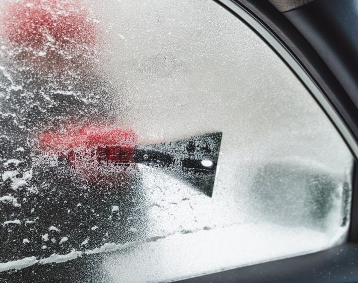 Scraping ice from a car window