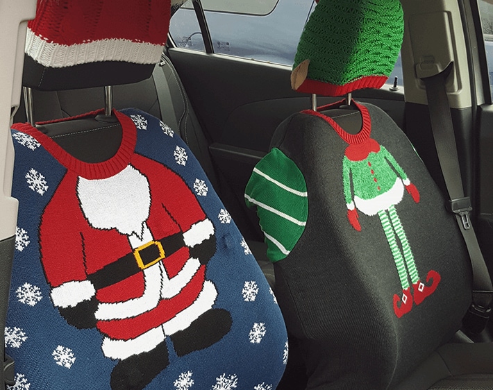 Car seats covered with festive ugly sweaters