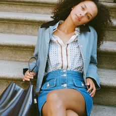 Woman in blue coat and print shirt