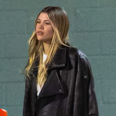 Sofia Richie wears a black leather bomber jacket.