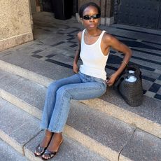 woman in white tank and jeans